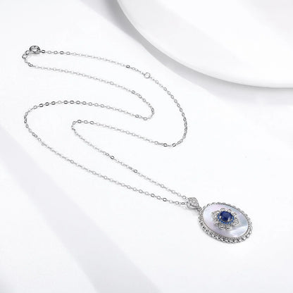 Elegant sterling silver pendant necklace with sparkling sapphires and diamonds, perfect for fashion-forward women