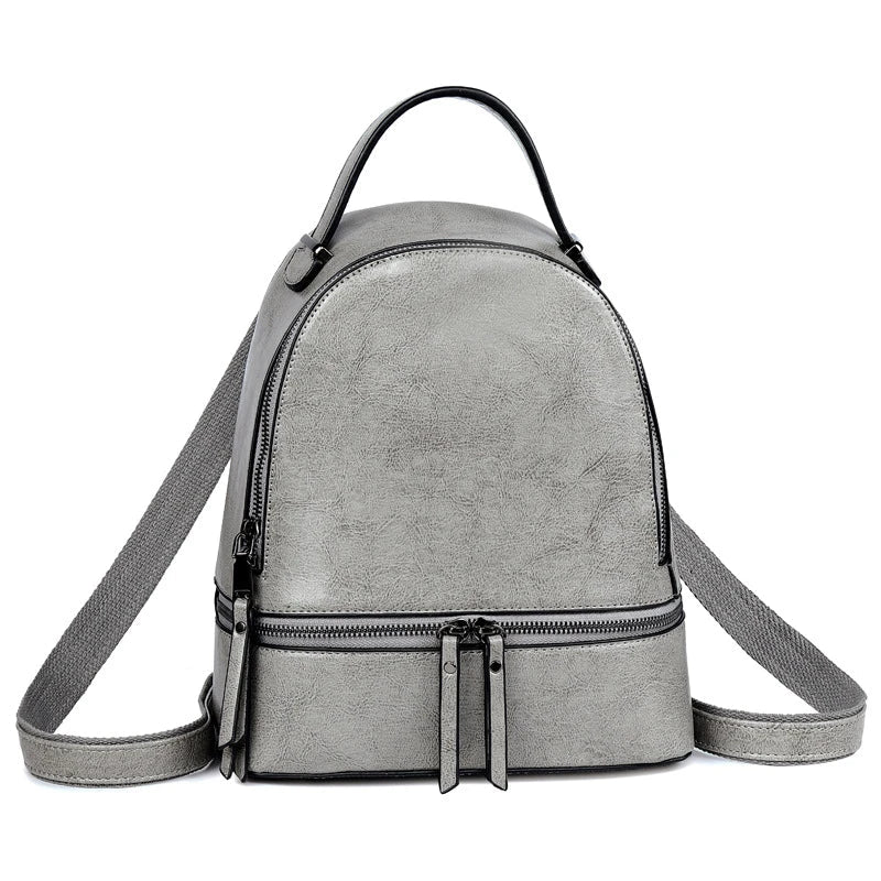 A stylish leather backpack in a variety of colours, featuring a classic oil-waxed cowhide design and practical storage compartments.