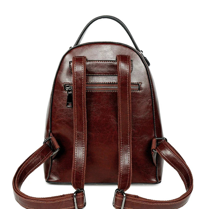A stylish leather backpack in a variety of colours, featuring a classic oil-waxed cowhide design and practical storage compartments.