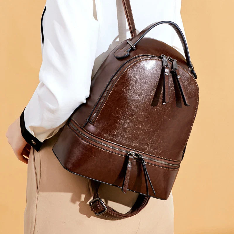 A stylish leather backpack in a variety of colours, featuring a classic oil-waxed cowhide design and practical storage compartments.