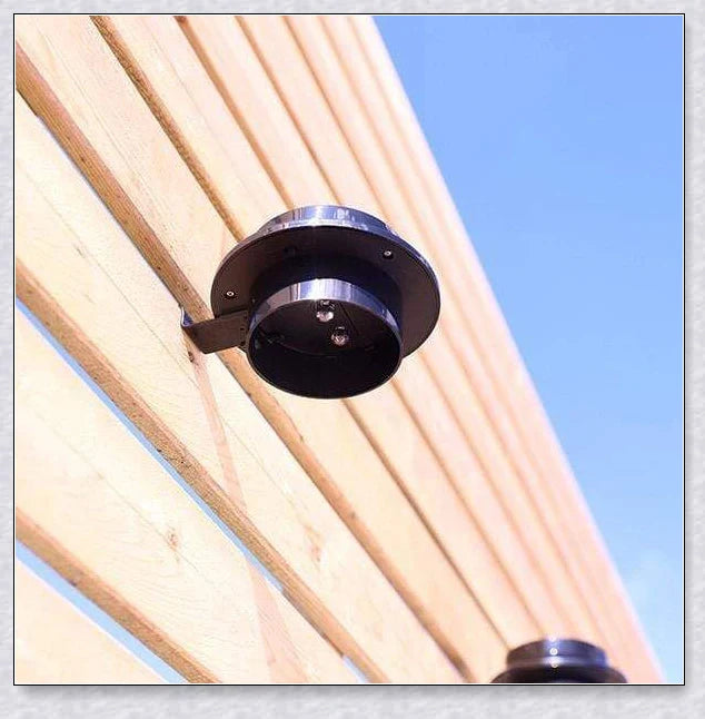 Premium solar-powered gutter lights illuminating an outdoor patio area at night