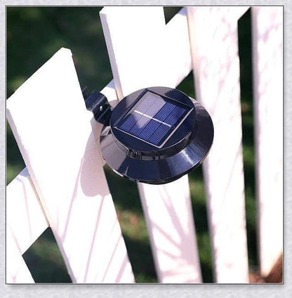 Premium solar-powered gutter lights illuminating an outdoor patio area at night