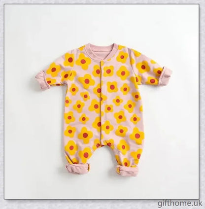 A cosy baby romper with charming cartoon designs, made from soft and breathable cotton fabric.