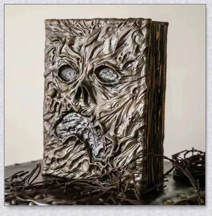 Aged Necronomicon prop with demonic face cover, perfect for dark fantasy decor