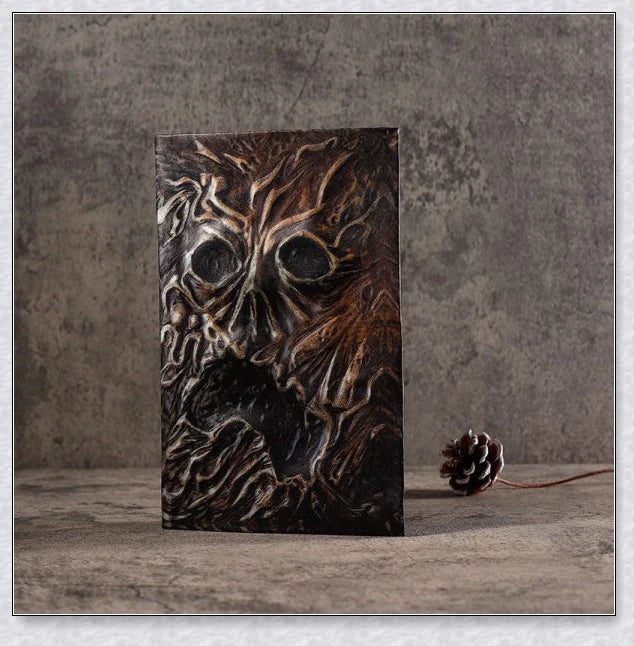 Aged Necronomicon prop with demonic face cover, perfect for dark fantasy decor