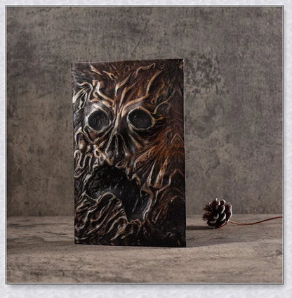 Aged Necronomicon prop with demonic face cover, perfect for dark fantasy decor