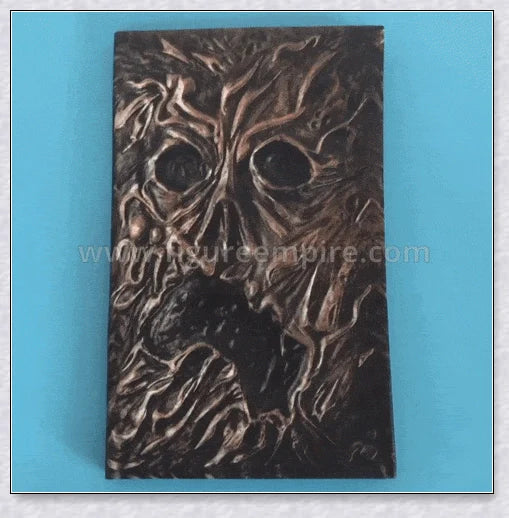 Aged Necronomicon prop with demonic face cover, perfect for dark fantasy decor