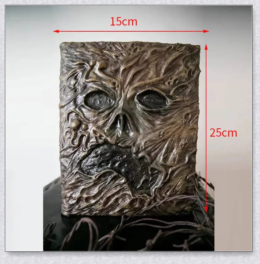 Aged Necronomicon prop with demonic face cover, perfect for dark fantasy decor