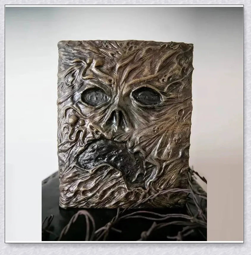 Aged Necronomicon prop with demonic face cover, perfect for dark fantasy decor