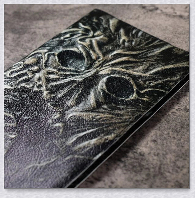 Aged Necronomicon prop with demonic face cover, perfect for dark fantasy decor