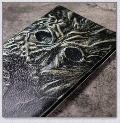 Aged Necronomicon prop with demonic face cover, perfect for dark fantasy decor