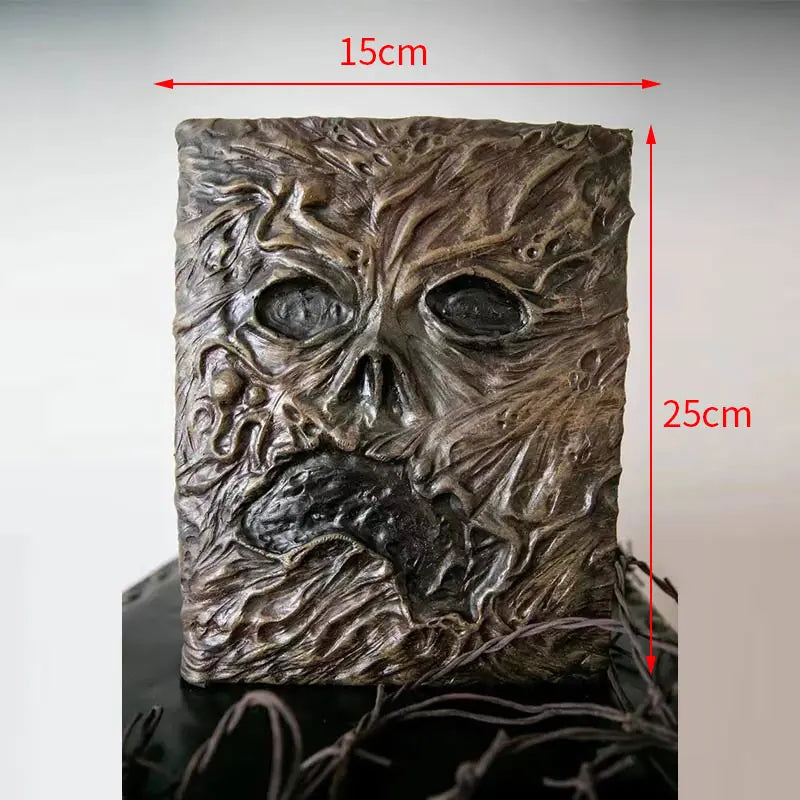 Aged Necronomicon prop with demonic face cover, perfect for dark fantasy decor
