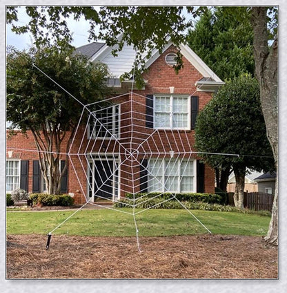 Massive black and white Halloween spider web decoration that stretches across large areas, creating a haunting atmosphere