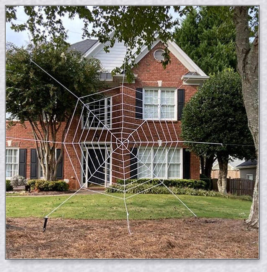 Massive black and white Halloween spider web decoration that stretches across large areas, creating a haunting atmosphere
