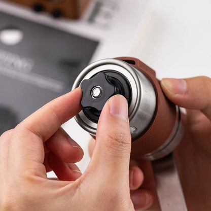 Portable hand coffee machine with stainless steel grinder and folding handle