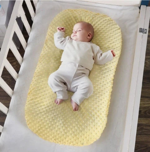 Newborn bionic nap bed in blue and yellow, designed for safety and comfort