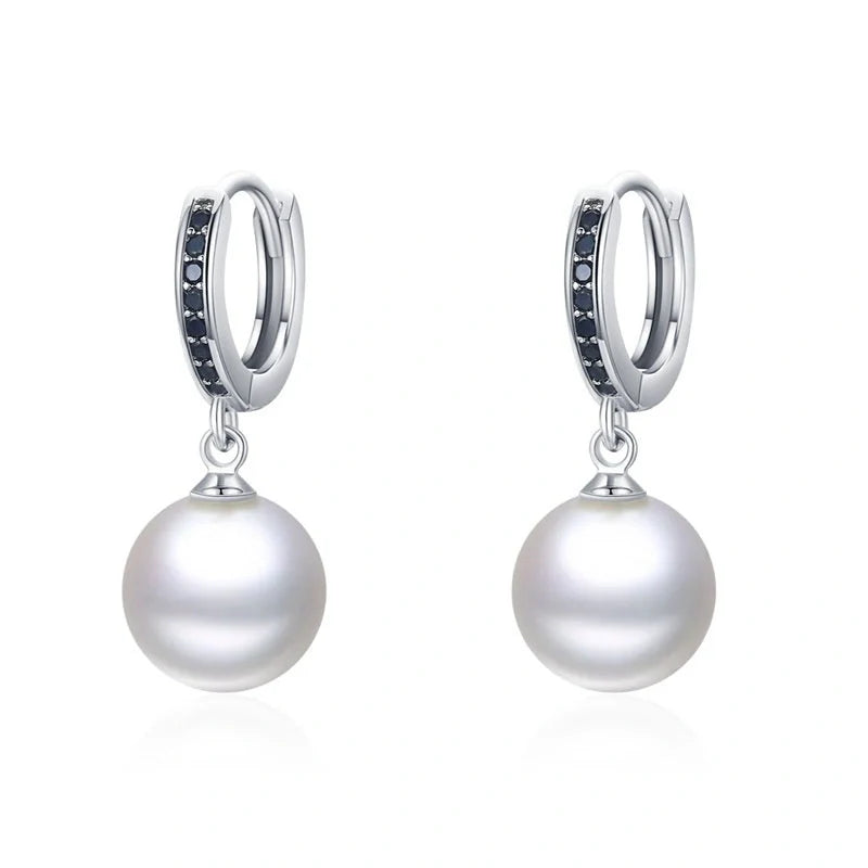 Trendy copper ball stud earrings with a minimalist design, showcasing a sleek and modern accessory for fashion-forward women