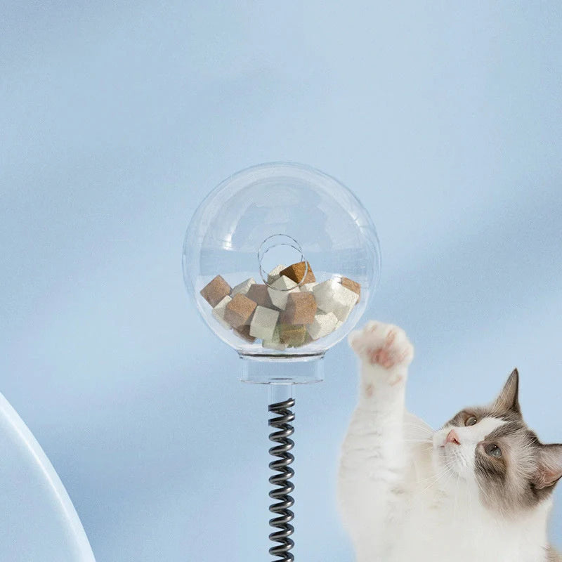 Interactive cat toy with treat dispenser and spring ball in blue, yellow, green