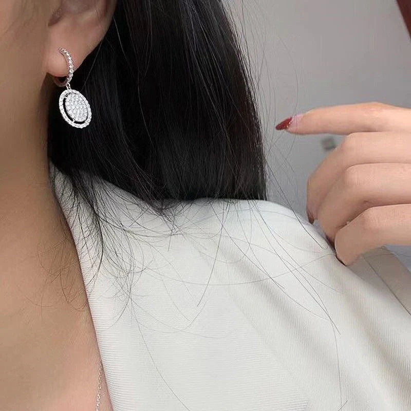 Elegant white gold plated oval earrings for women, perfect for any occasion.