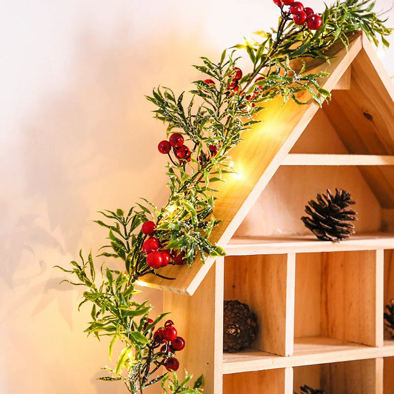 Festive Christmas lights with a decorative leaf garland, creating a cosy, enchanting display for the holiday season