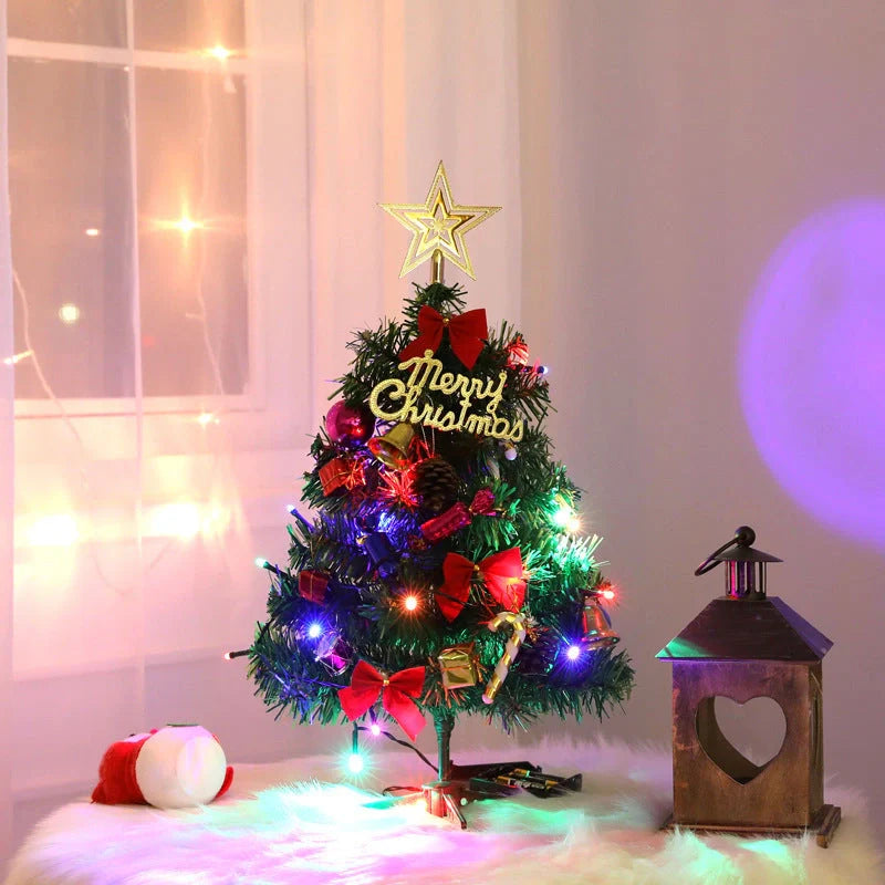 Mini Christmas tree with snowflake LED lights and decorative bows, bells, and pine cones