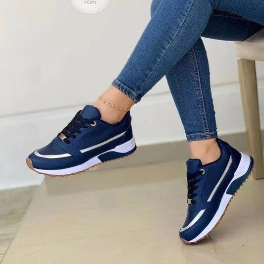 Stylish lace-up sneakers with synthetic leather upper and cushioned sole for casual comfort and versatile style.