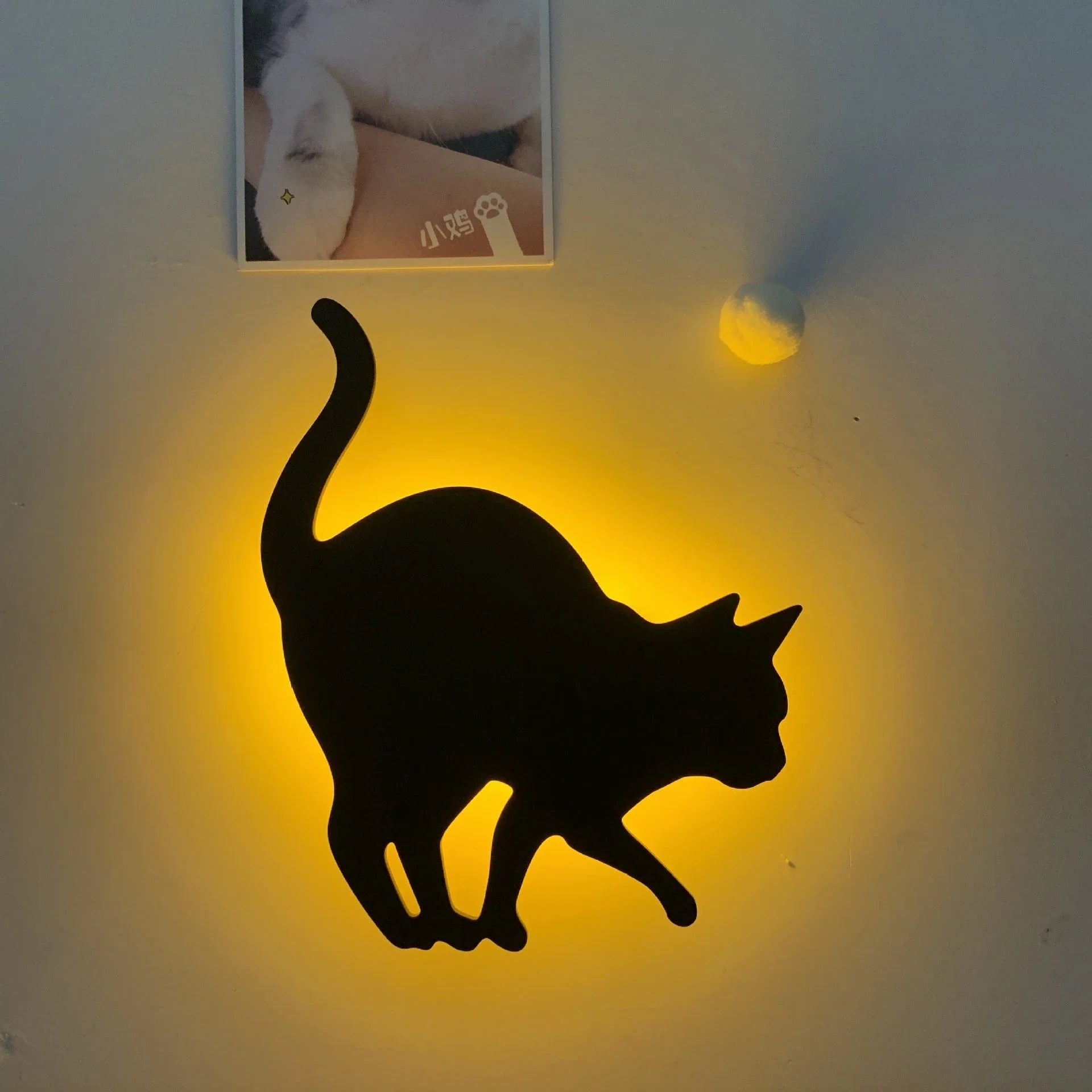 A stylish cat-shaped smart sensor night light that automatically illuminates a room when motion is detected, creating a warm and cozy atmosphere.