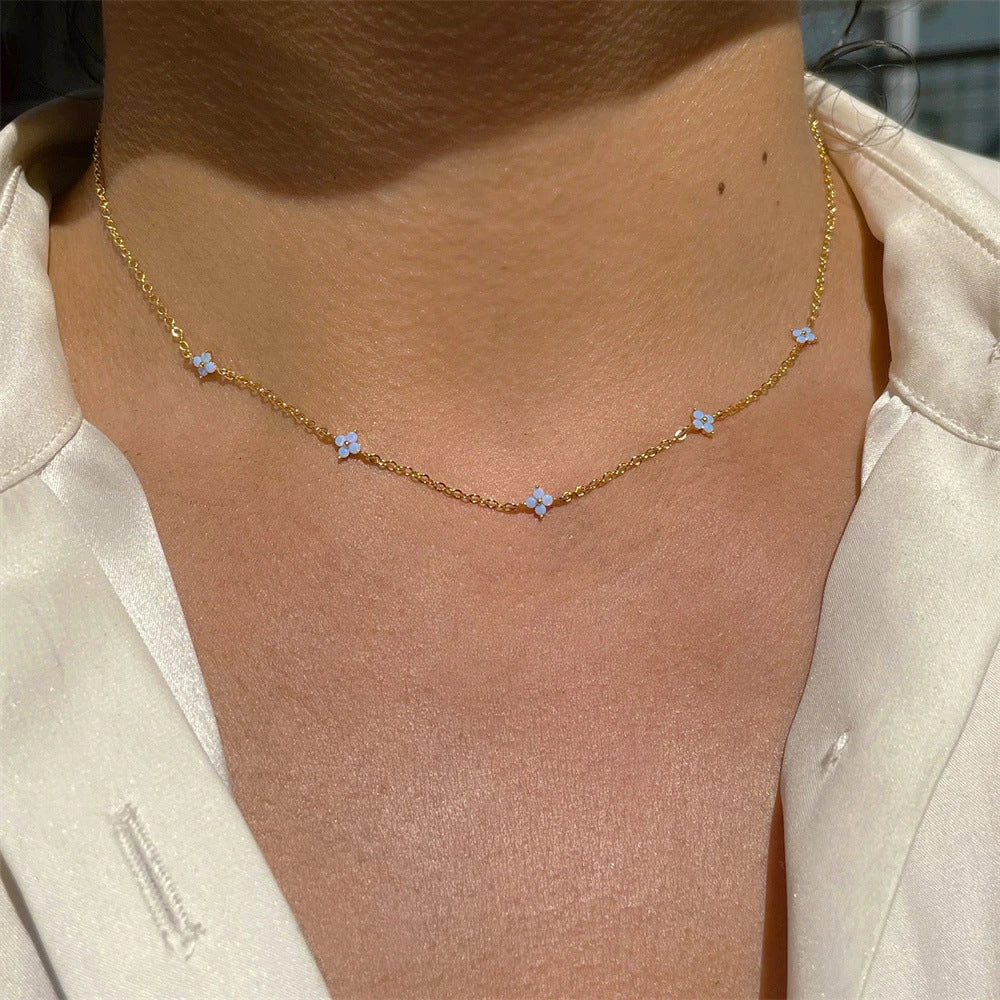 Elegant floral statement necklace in various color options, including golden blue, silver blue, golden green, and silver green, with an adjustable chain and high-quality construction.