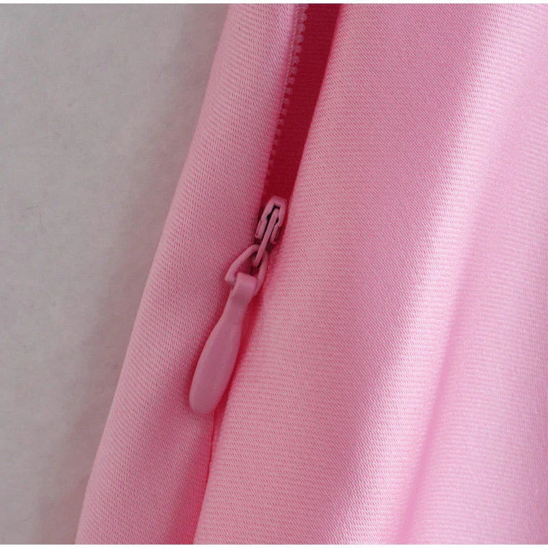 A sleek and elegant satin slip dress in a stunning pink color with a backless design and full-length silhouette.