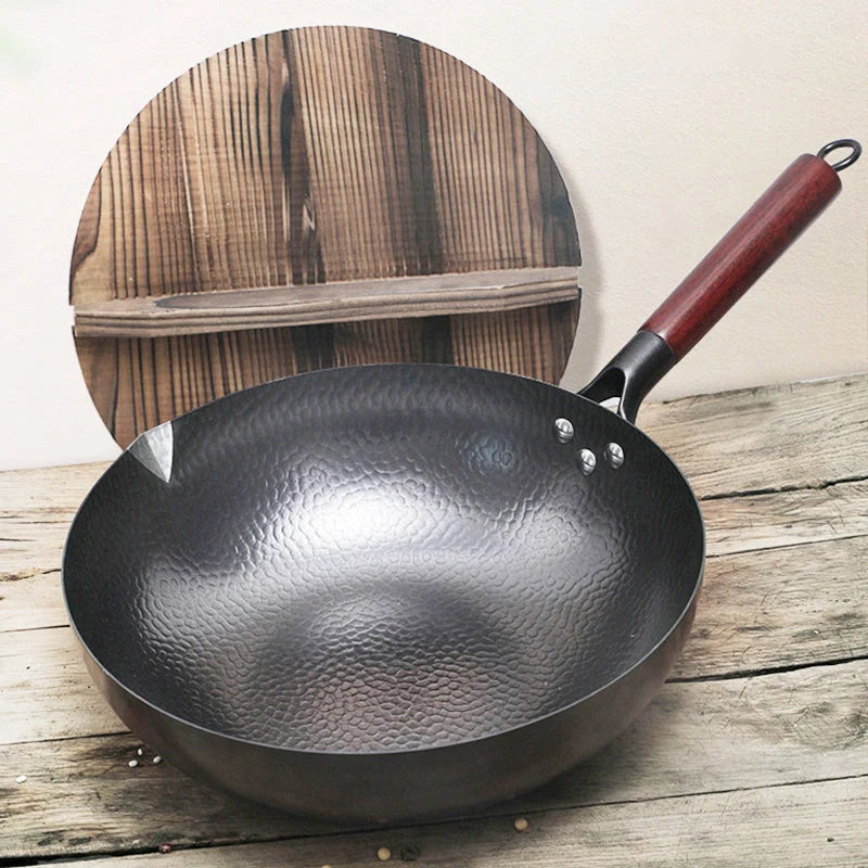 Traditional handmade iron wok with wooden handle and lid