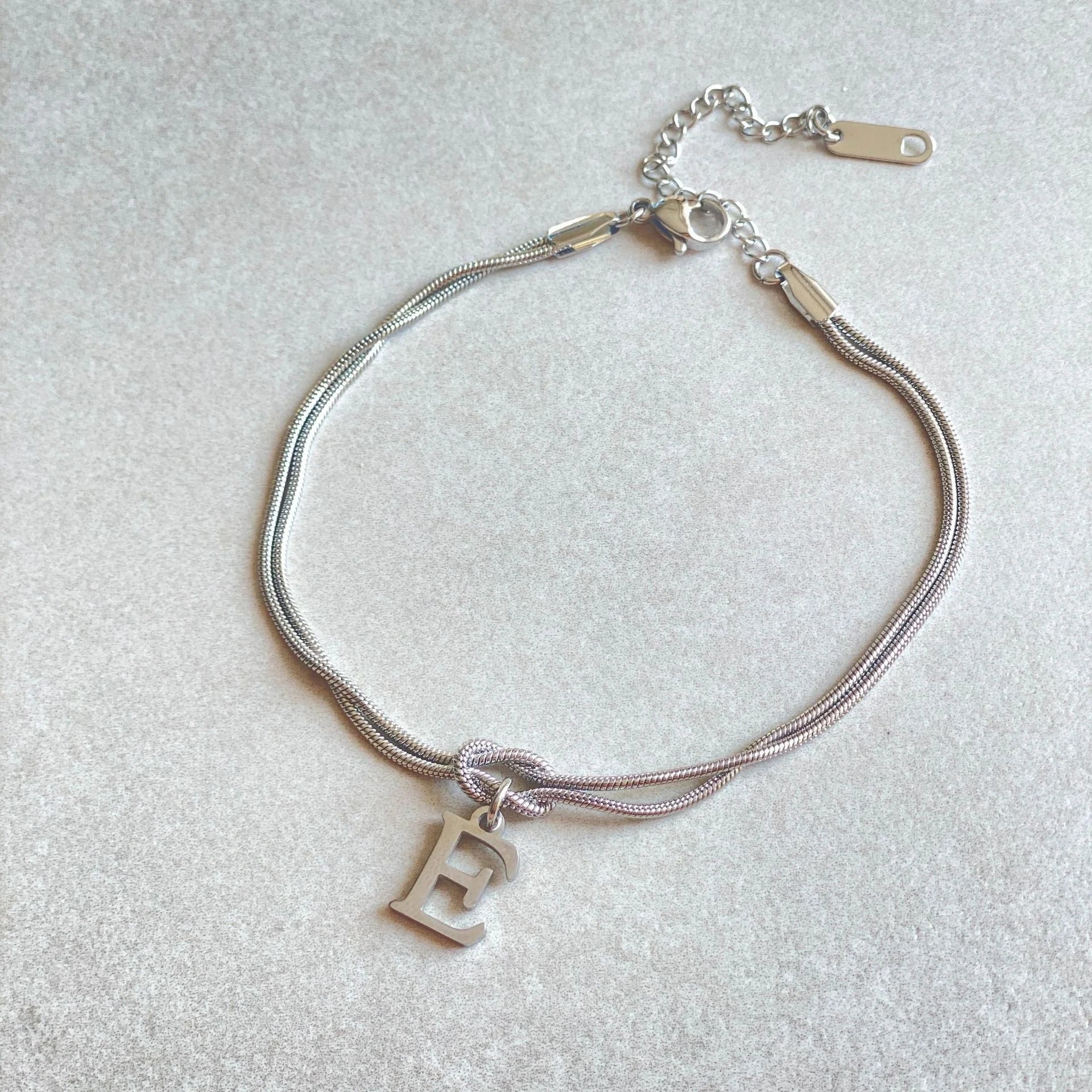 Personalised gold and silver love knot bracelets for couples, perfect as Valentine's Day gifts.