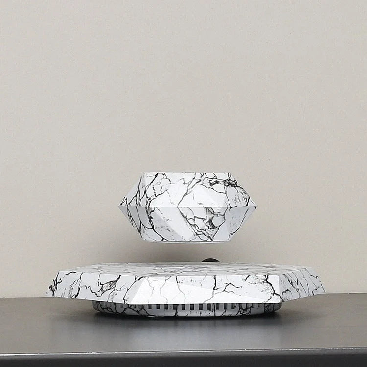 Levitating marble bonsai pot floating above magnetic base