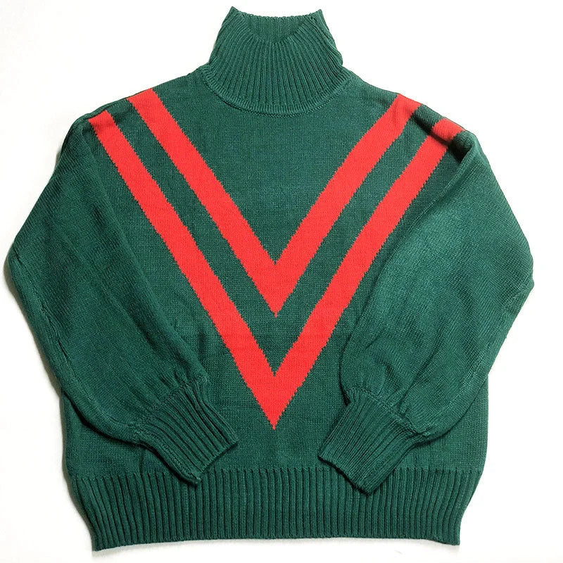 A green turtleneck sweater with a high collar, relaxed fit, and vintage-inspired design, perfect for British fashion enthusiasts.