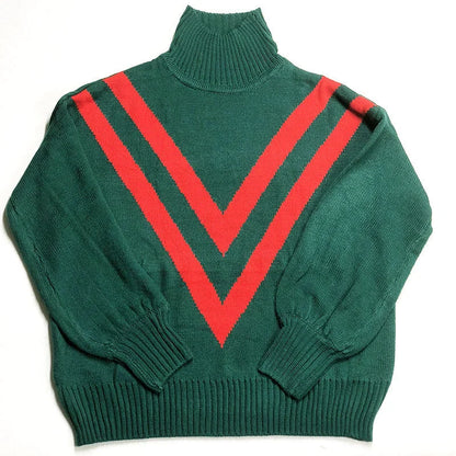 A green turtleneck sweater with a high collar, relaxed fit, and vintage-inspired design, perfect for British fashion enthusiasts.