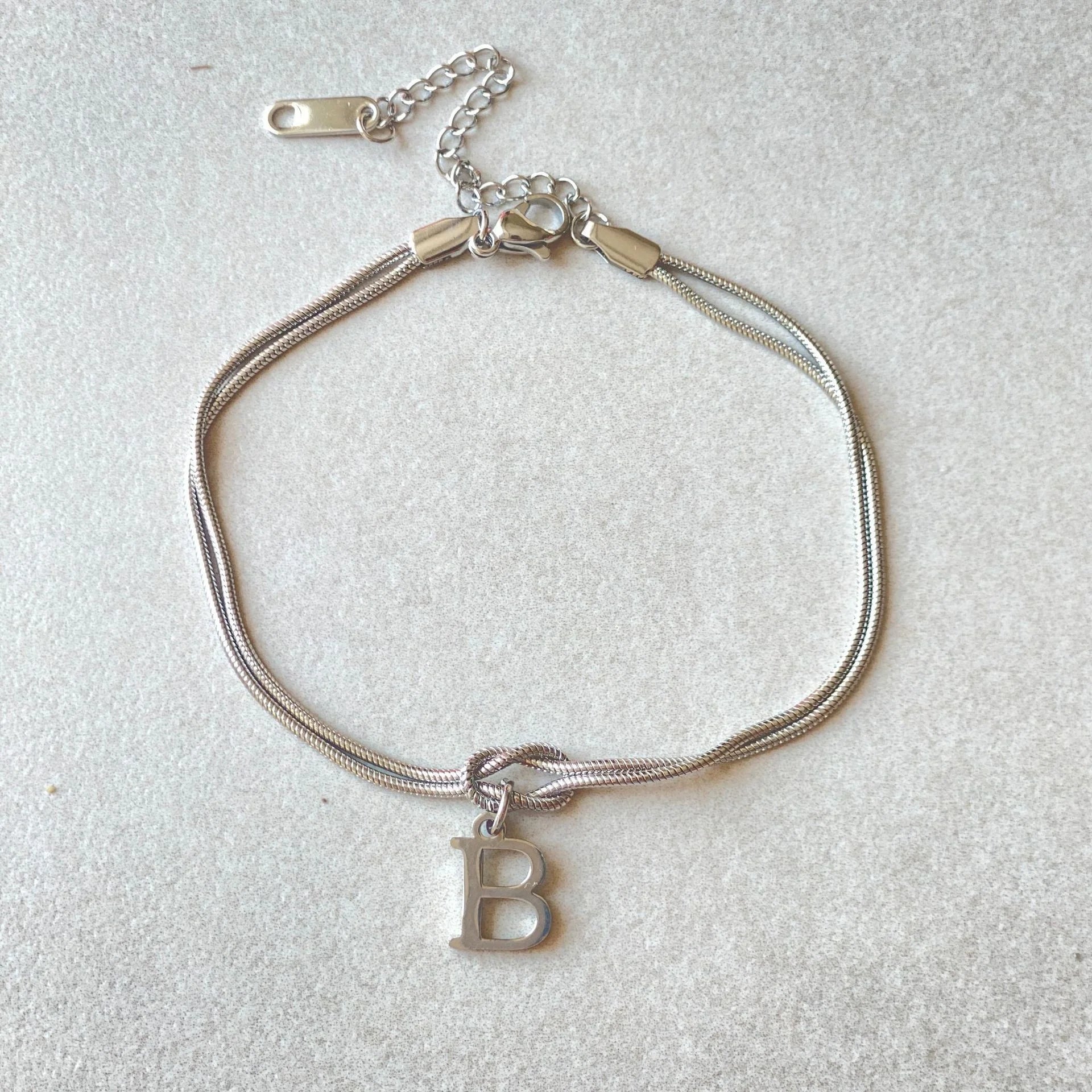Personalised gold and silver love knot bracelets for couples, perfect as Valentine's Day gifts.