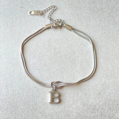 Personalised gold and silver love knot bracelets for couples, perfect as Valentine's Day gifts.