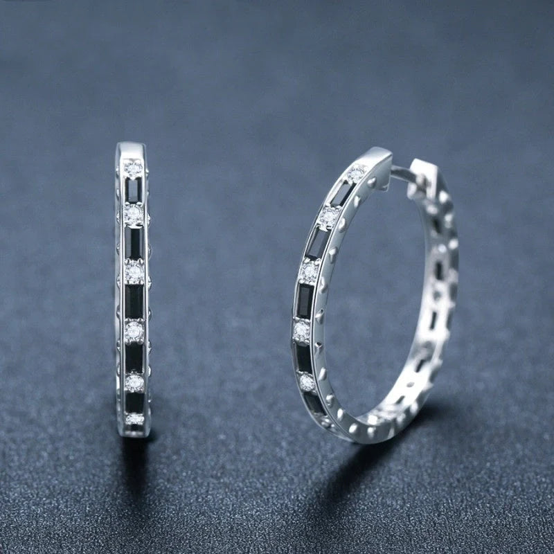 A pair of elegant black zircon earrings with a round, geometric design made of premium copper