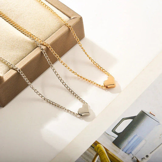 Elegant gold-tone double-sided love pendant necklace with a sleek clavicle chain design