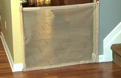 Versatile foldable pet safety barrier made of durable mesh fabric and stainless steel for use in doorways, walls, and stairs