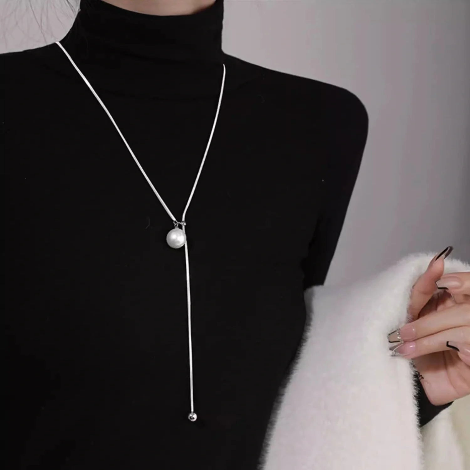 Platinum-plated round ball necklace with snake-bone chain, a versatile and elegant accessory for fashion-forward British women