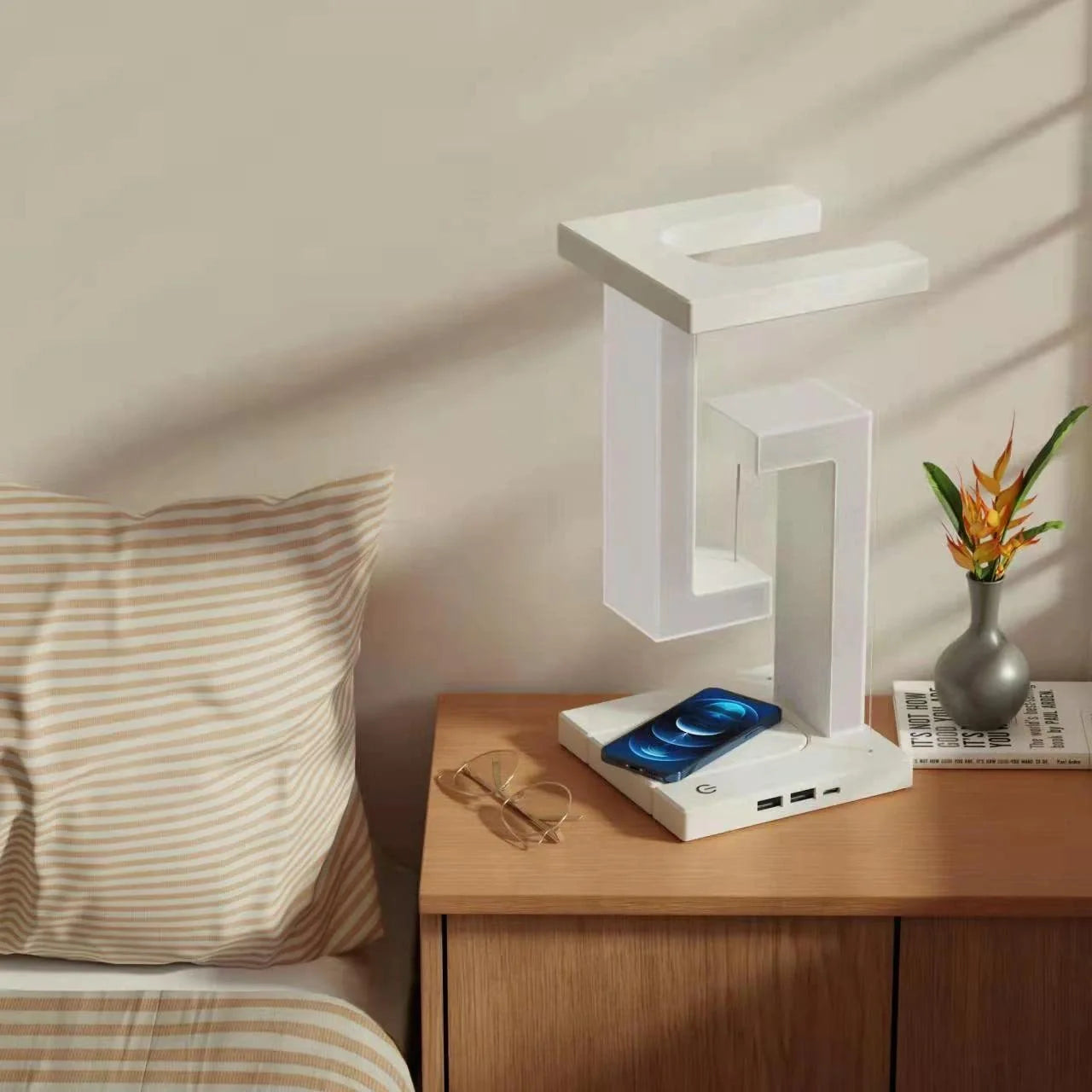 Floating table lamp with wireless charging for smartphones in modern minimalist design
