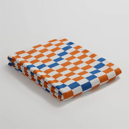 Cosy plaid blanket in a vibrant blue colour, perfect for adding warmth and charm to any indoor or outdoor setting.