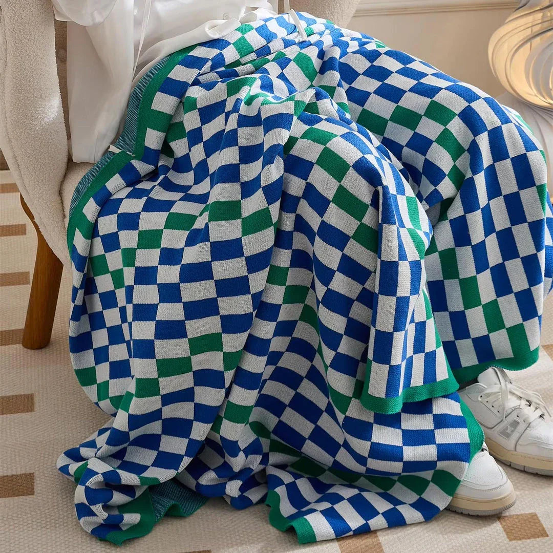 Cosy plaid blanket in a vibrant blue colour, perfect for adding warmth and charm to any indoor or outdoor setting.