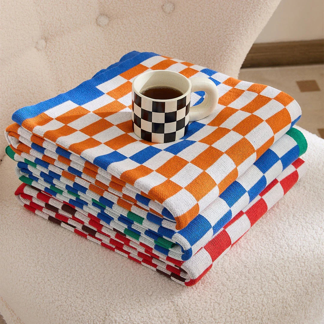 Cosy plaid blanket in a vibrant blue colour, perfect for adding warmth and charm to any indoor or outdoor setting.