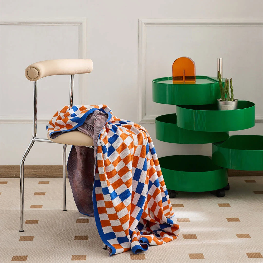 Cosy plaid blanket in a vibrant blue colour, perfect for adding warmth and charm to any indoor or outdoor setting.