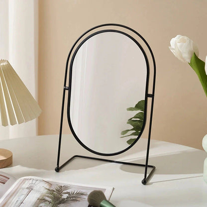 A large, minimalist desktop makeup mirror with a sleek black frame and a spacious viewing area for detailed grooming and makeup application.