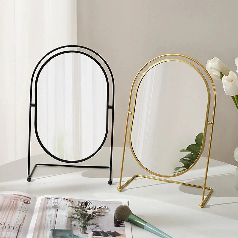 A large, minimalist desktop makeup mirror with a sleek black frame and a spacious viewing area for detailed grooming and makeup application.