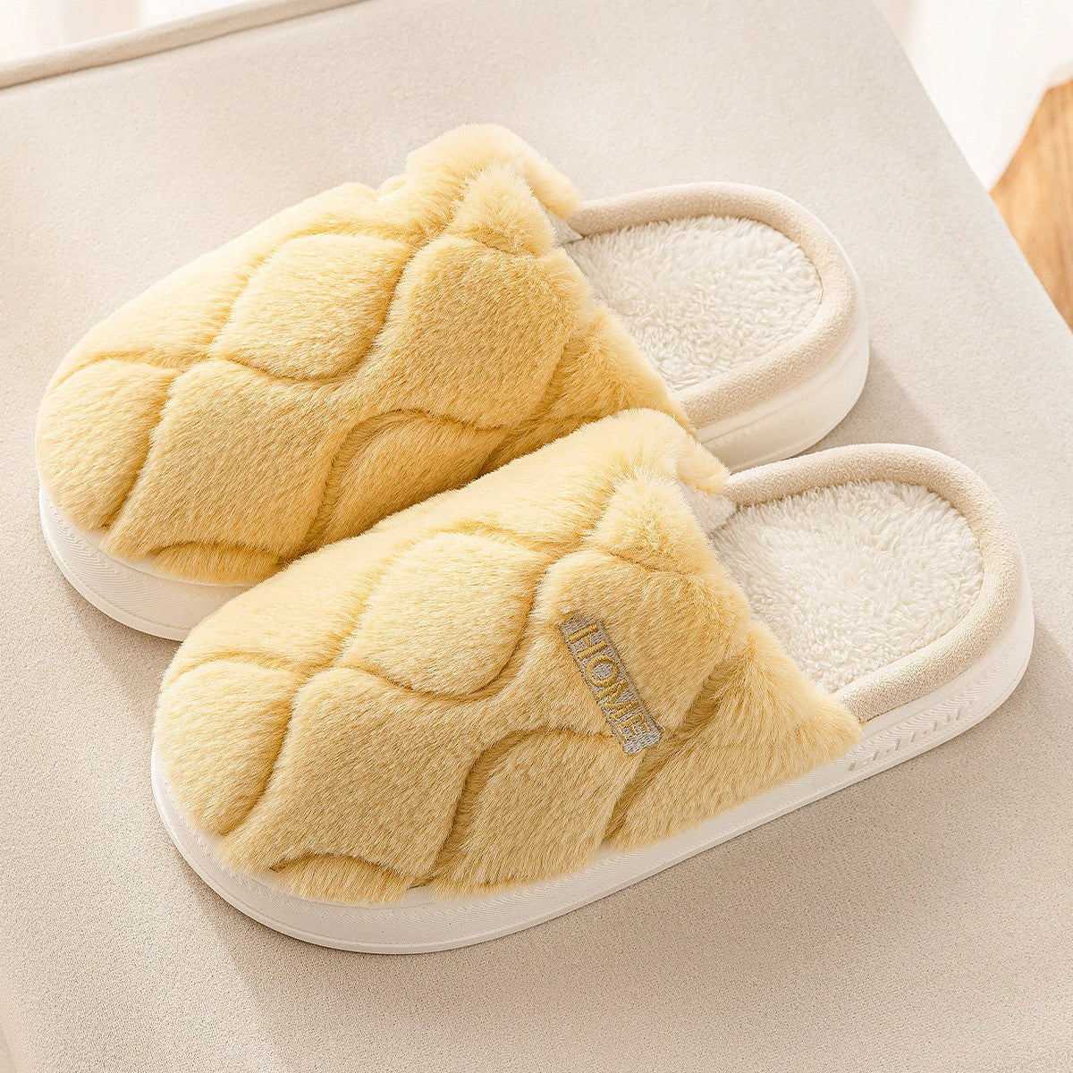 Plush slippers with soft, cushiony upper and durable PVC sole for cozy indoor comfort and traction
