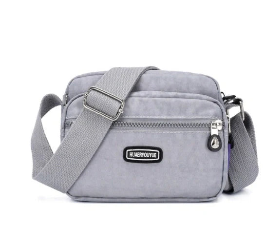 Small square messenger bag in water-repellent nylon with multi-compartment design