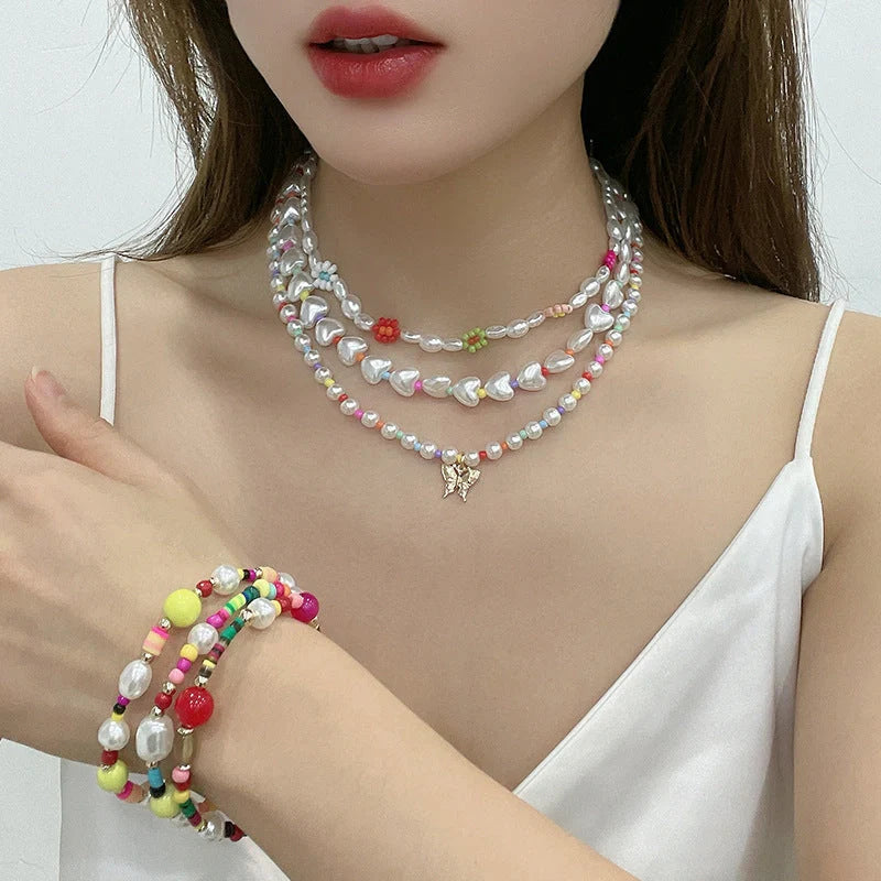A close-up view of a gold-plated multi-strand necklace featuring delicate imitation pearls arranged in a geometric pattern.